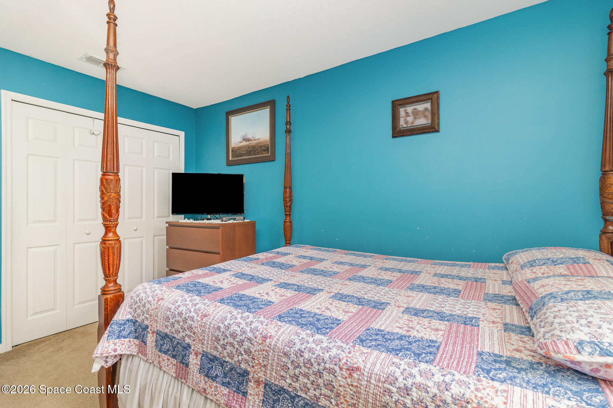 154 Wading Bird Circle Southwest Palm Bay, FL 32908 - Photo 38 of 45 a bedroom with a bed and a flat screen tv