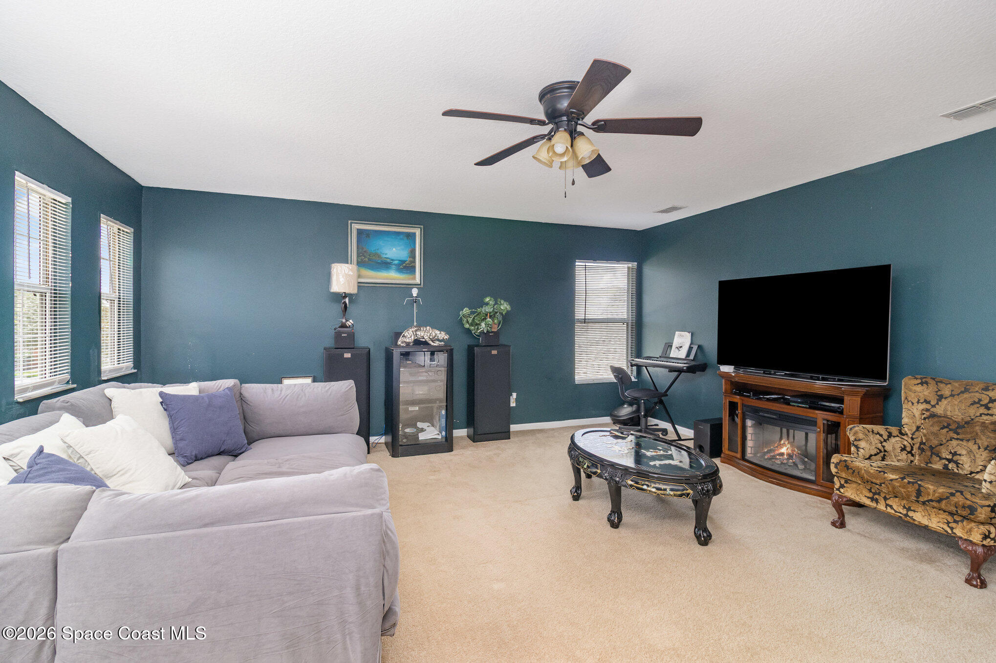 154 Wading Bird Circle Southwest Palm Bay, FL 32908 - Photo 39 of 45 a living room with furniture and a flat screen tv