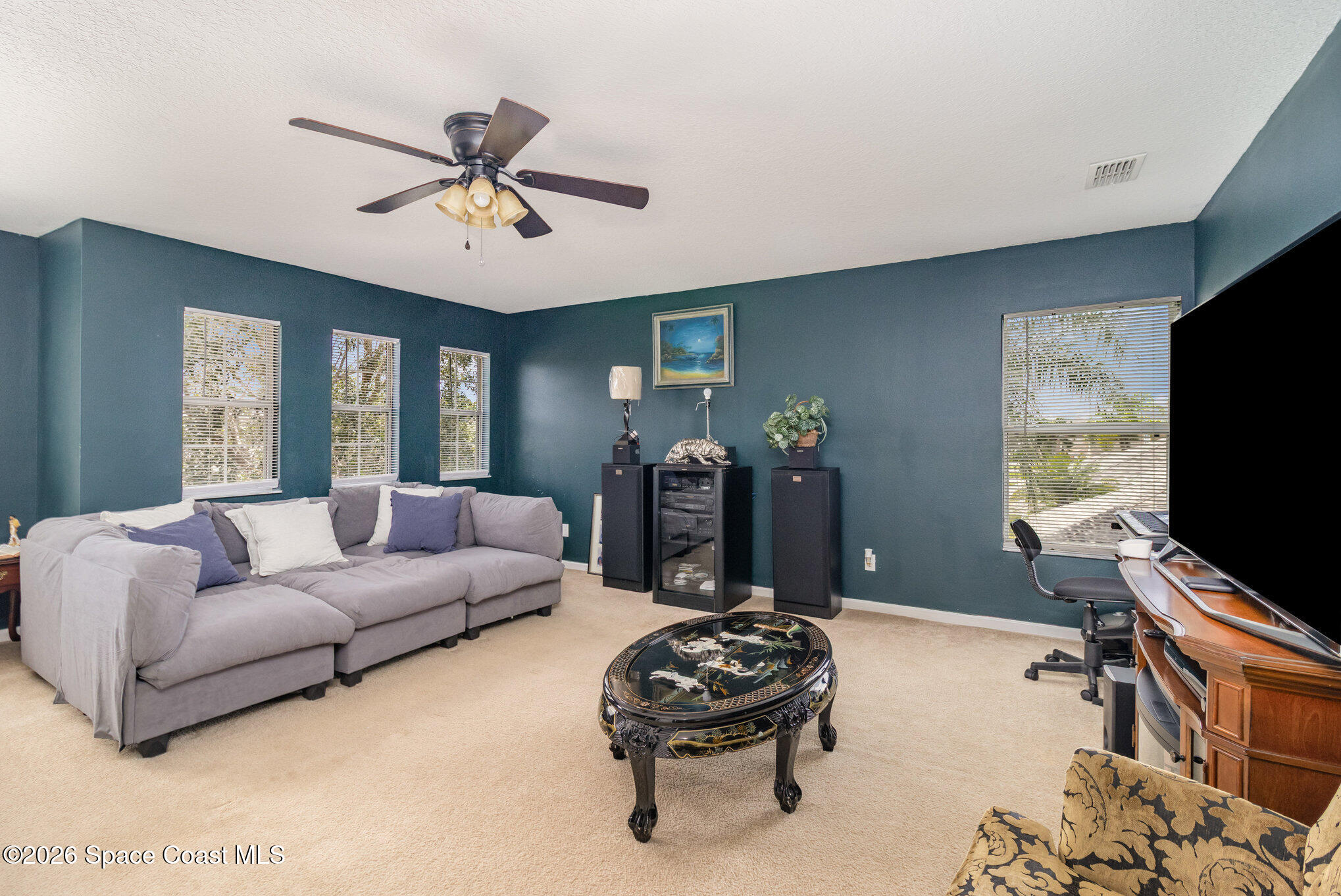 154 Wading Bird Circle Southwest Palm Bay, FL 32908 - Photo 40 of 45 a living room with furniture and a flat screen tv