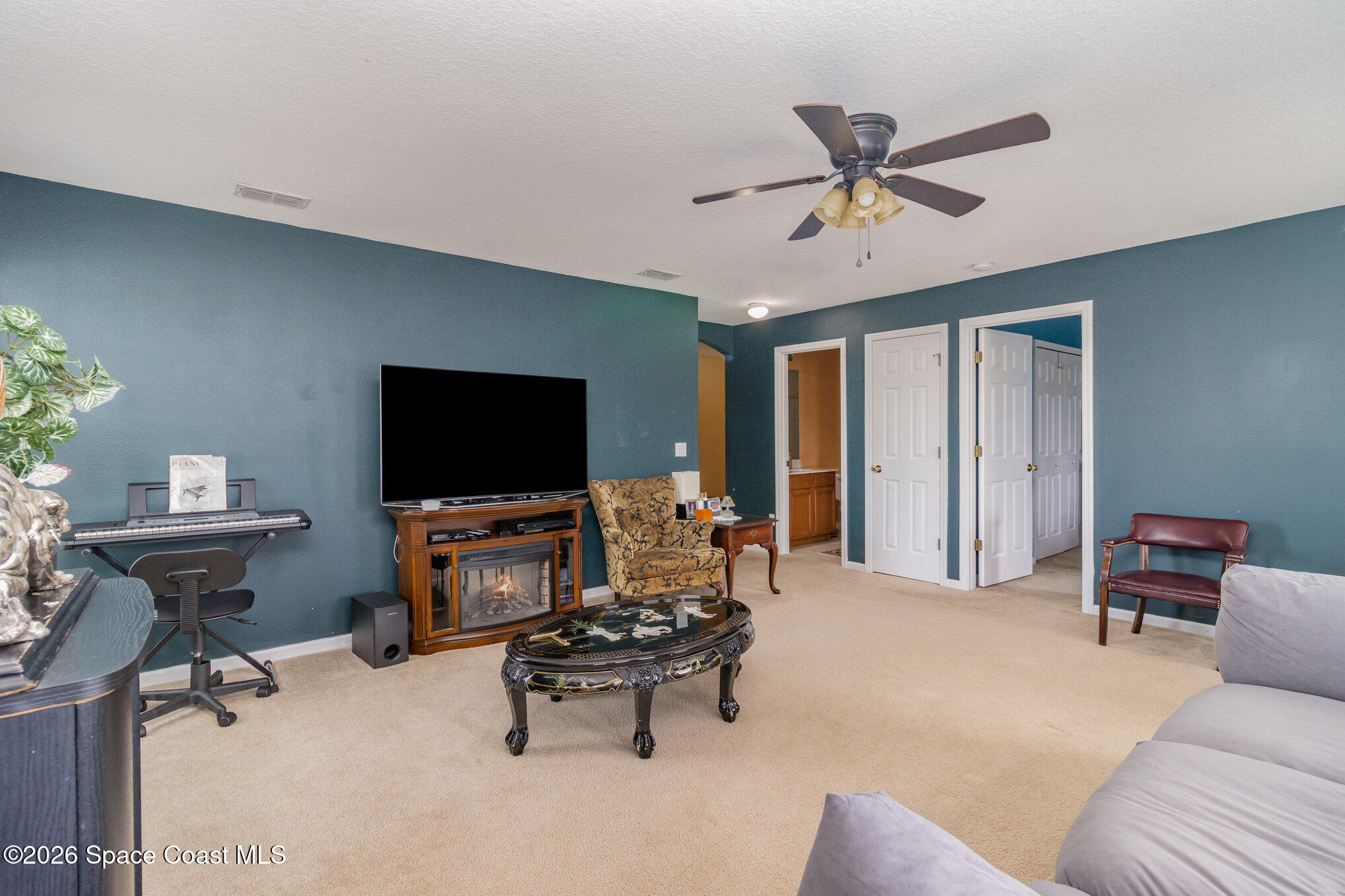 154 Wading Bird Circle Southwest Palm Bay, FL 32908 - Photo 41 of 45 a living room with furniture and a flat screen tv