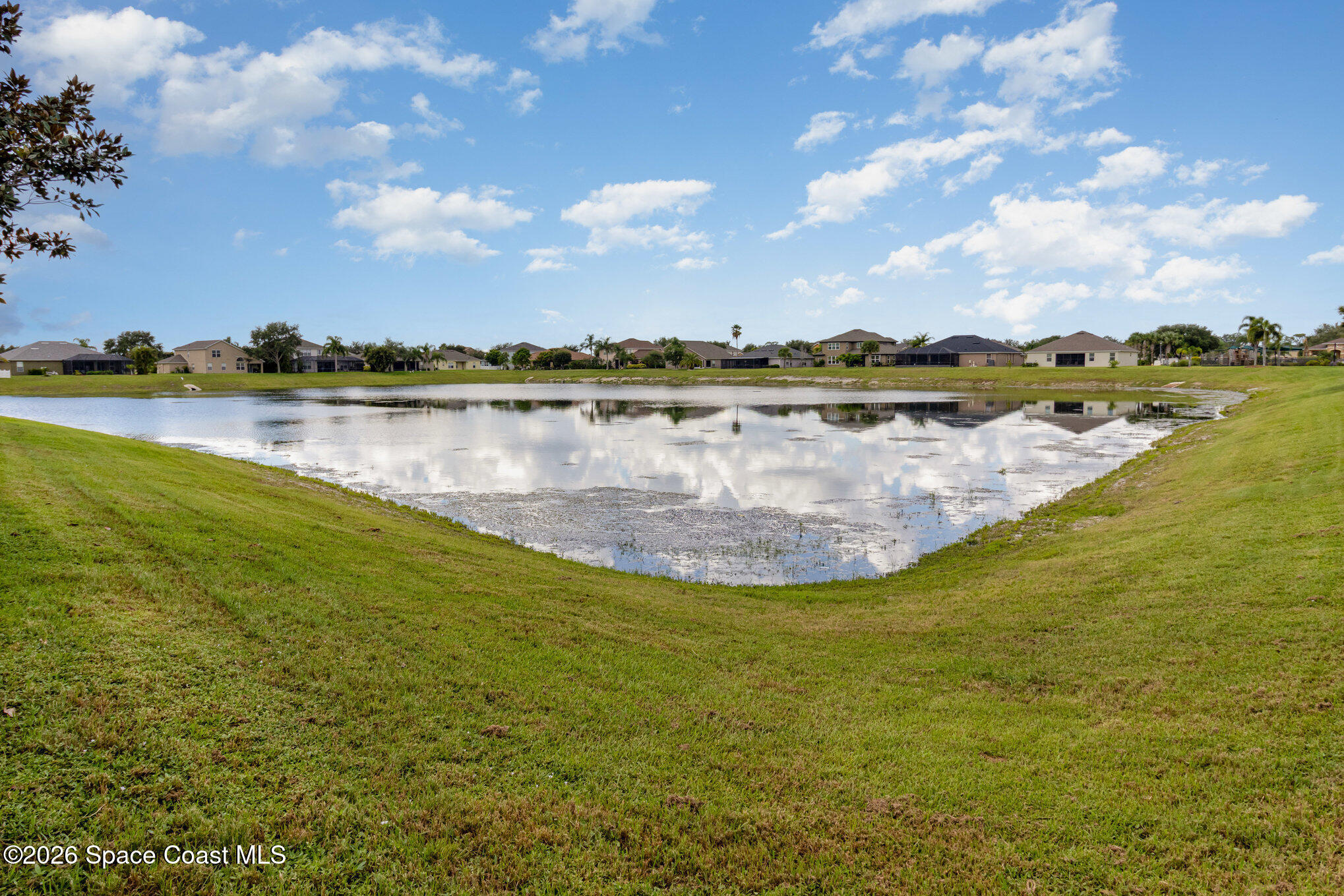 154 Wading Bird Circle Southwest Palm Bay, FL 32908 - Photo 42 of 45 a view of a lake in middle of a house with a lake view