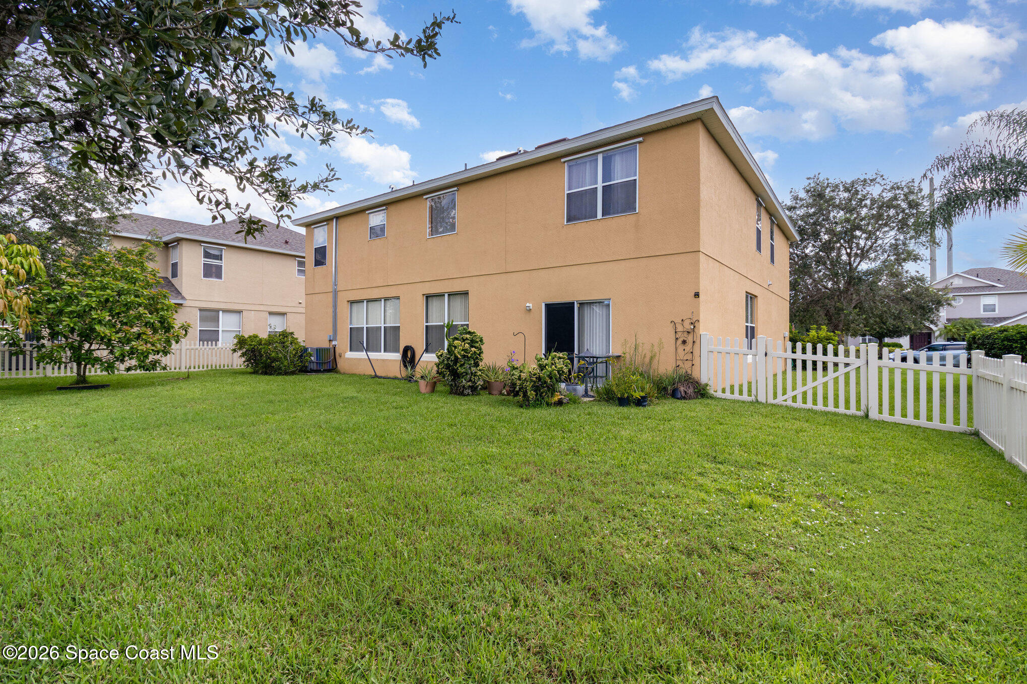 154 Wading Bird Circle Southwest Palm Bay, FL 32908 - Photo 44 of 45 a front view of a house with garden