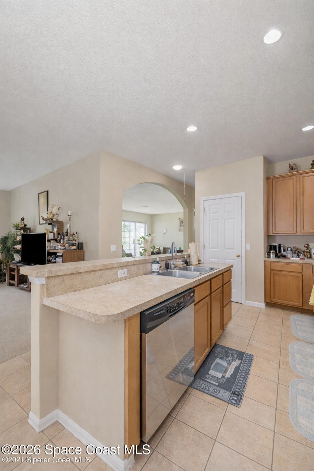 154 Wading Bird Circle Southwest Palm Bay, FL 32908 - Photo 5 of 45 a kitchen with stainless steel appliances granite countertop a sink and cabinets