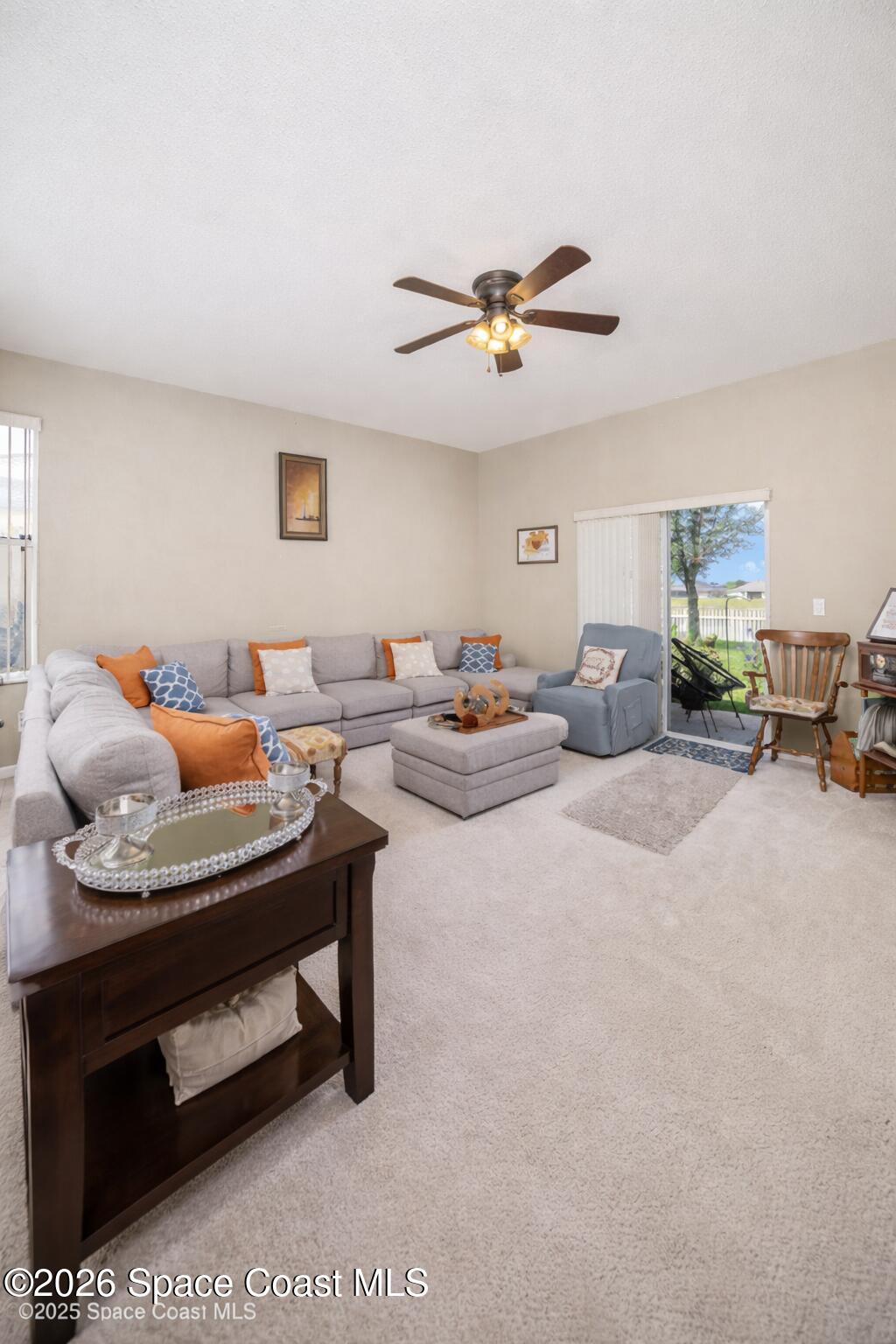 154 Wading Bird Circle Southwest Palm Bay, FL 32908 - Photo 7 of 45 a living room with furniture and a ceiling fan