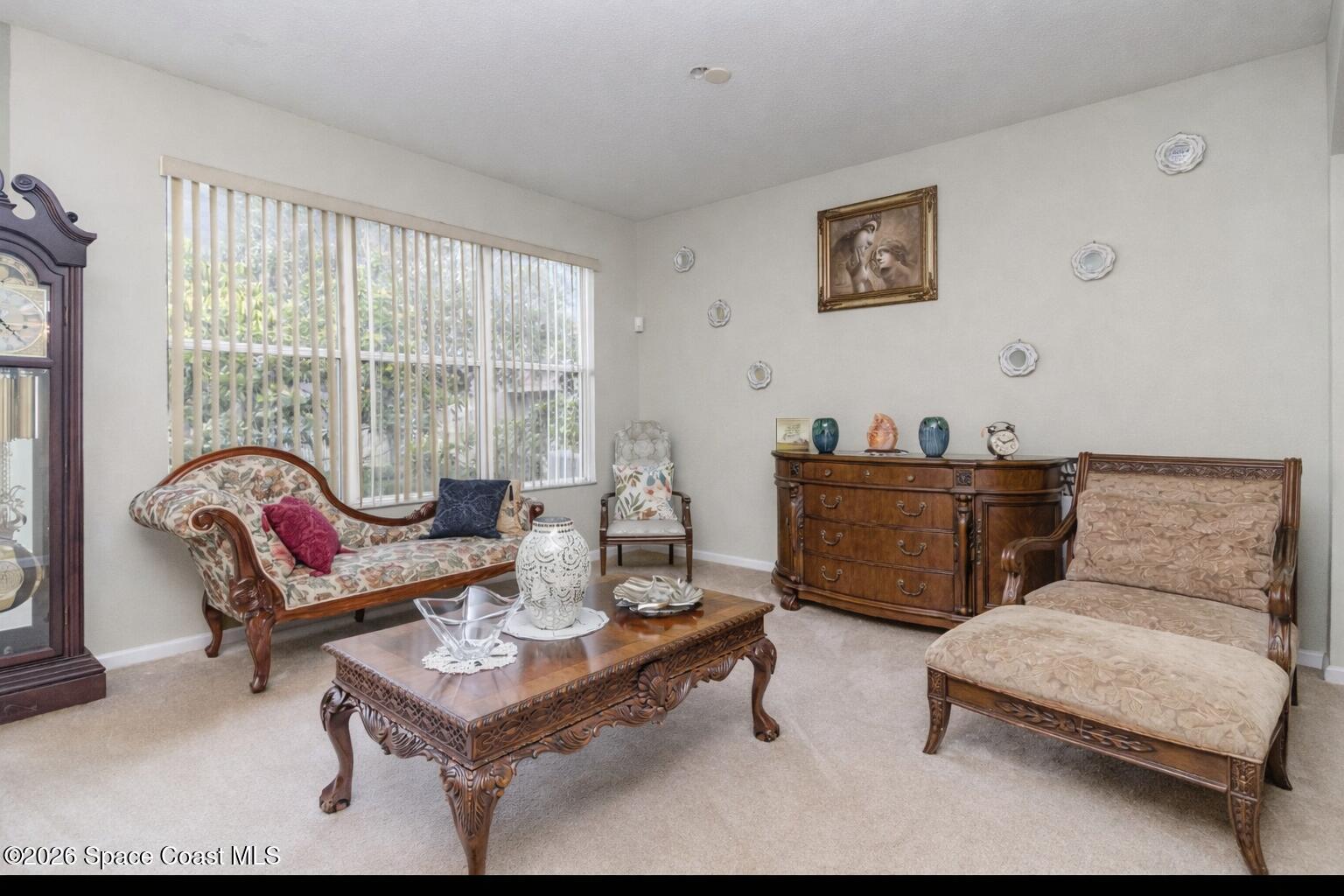 154 Wading Bird Circle Southwest Palm Bay, FL 32908 - Photo 9 of 45 a living room with furniture and a floor to ceiling window