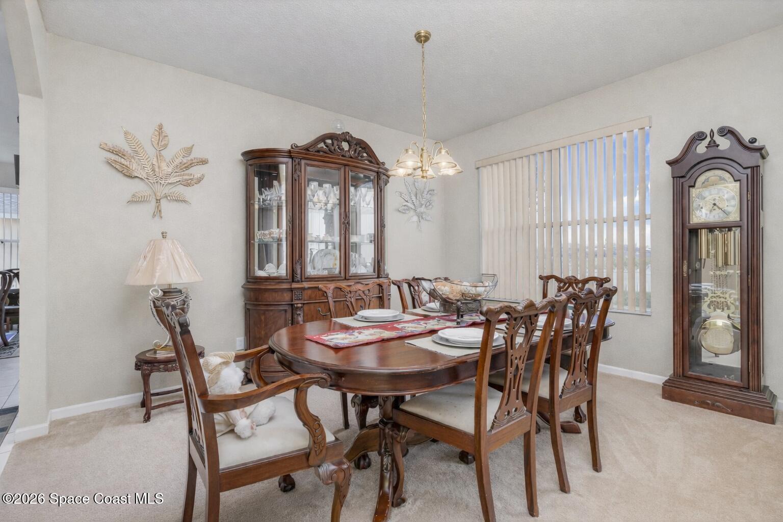 154 Wading Bird Circle Southwest Palm Bay, FL 32908 - Photo 10 of 45 a view of a dining room with furniture and a chandelier