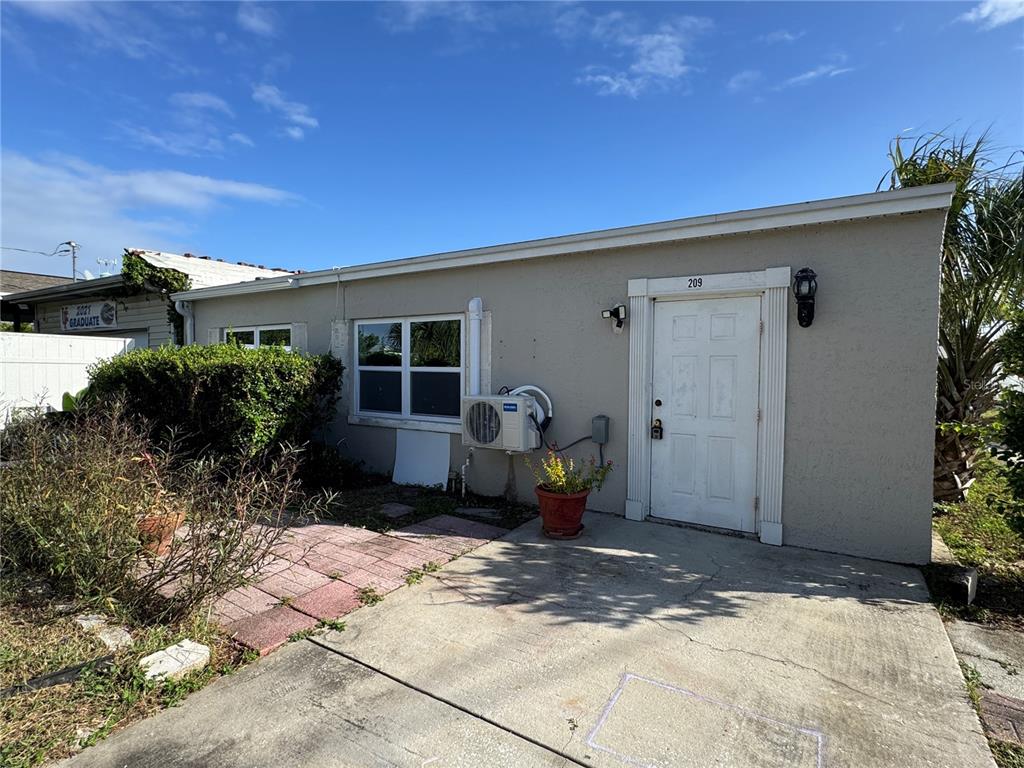 a backyard of a house with yard and outdoor seating