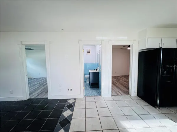 a kitchen with a refrigerator and cabinets