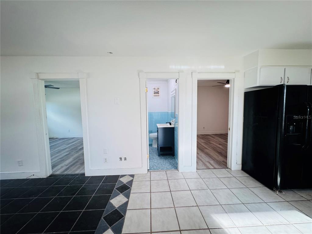 209 East Main Street Dundee, FL 33838 - Photo 5 of 13 a kitchen with a refrigerator and cabinets