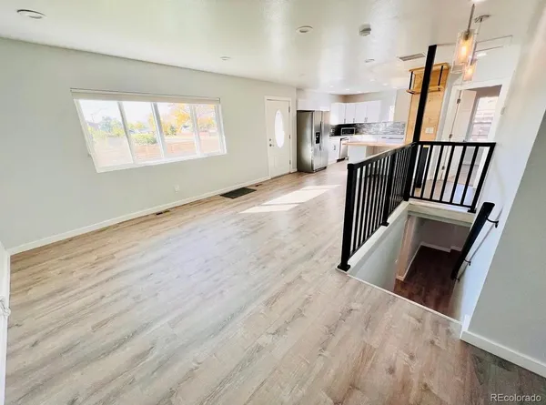 an entryway and livingroom with furniture