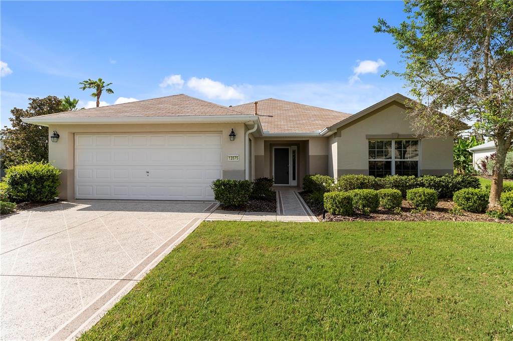 13575 Southeast 93rd Court Road Summerfield, FL 34491 - Photo 1 of 1 a front view of a house with a yard and garage