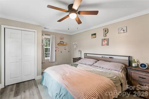 a bedroom with a large bed and a ceiling fan