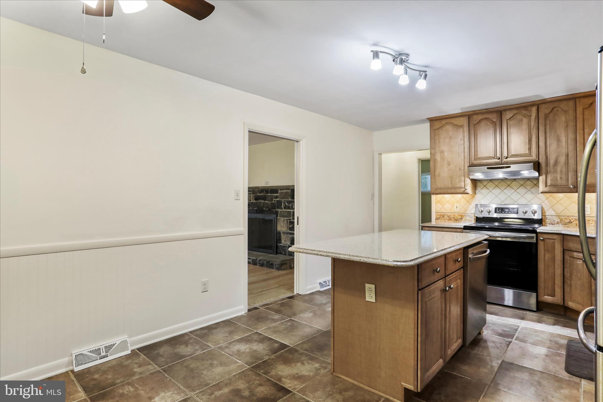 19734 Longmeadow Road Hagerstown, MD 21742 - Photo 14 of 45 a kitchen with kitchen island a sink stove and refrigerator