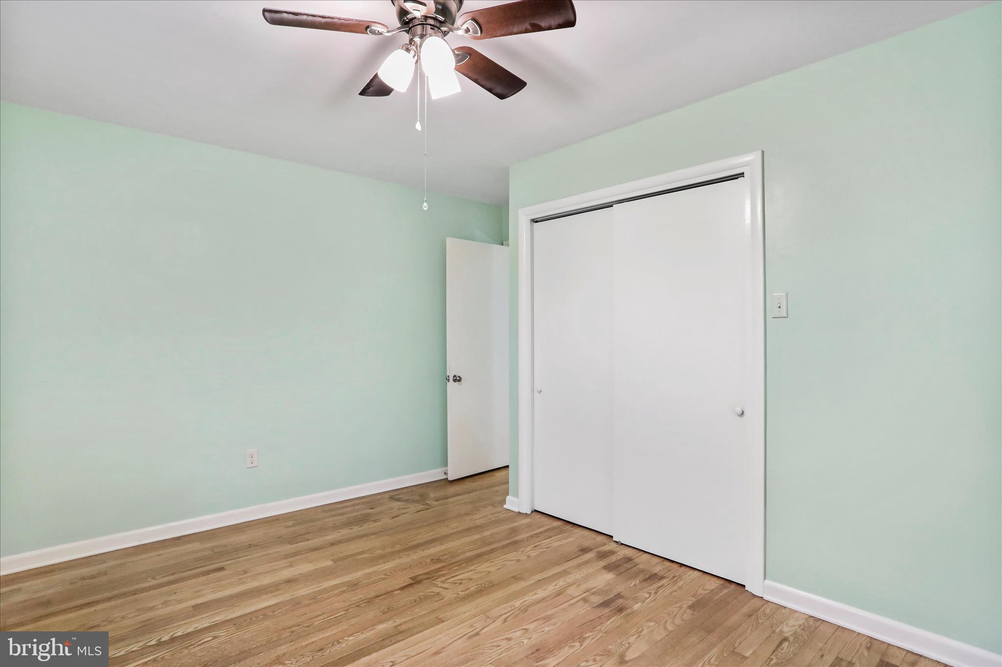 19734 Longmeadow Road Hagerstown, MD 21742 - Photo 17 of 45 an empty room with wooden floor fan and windows