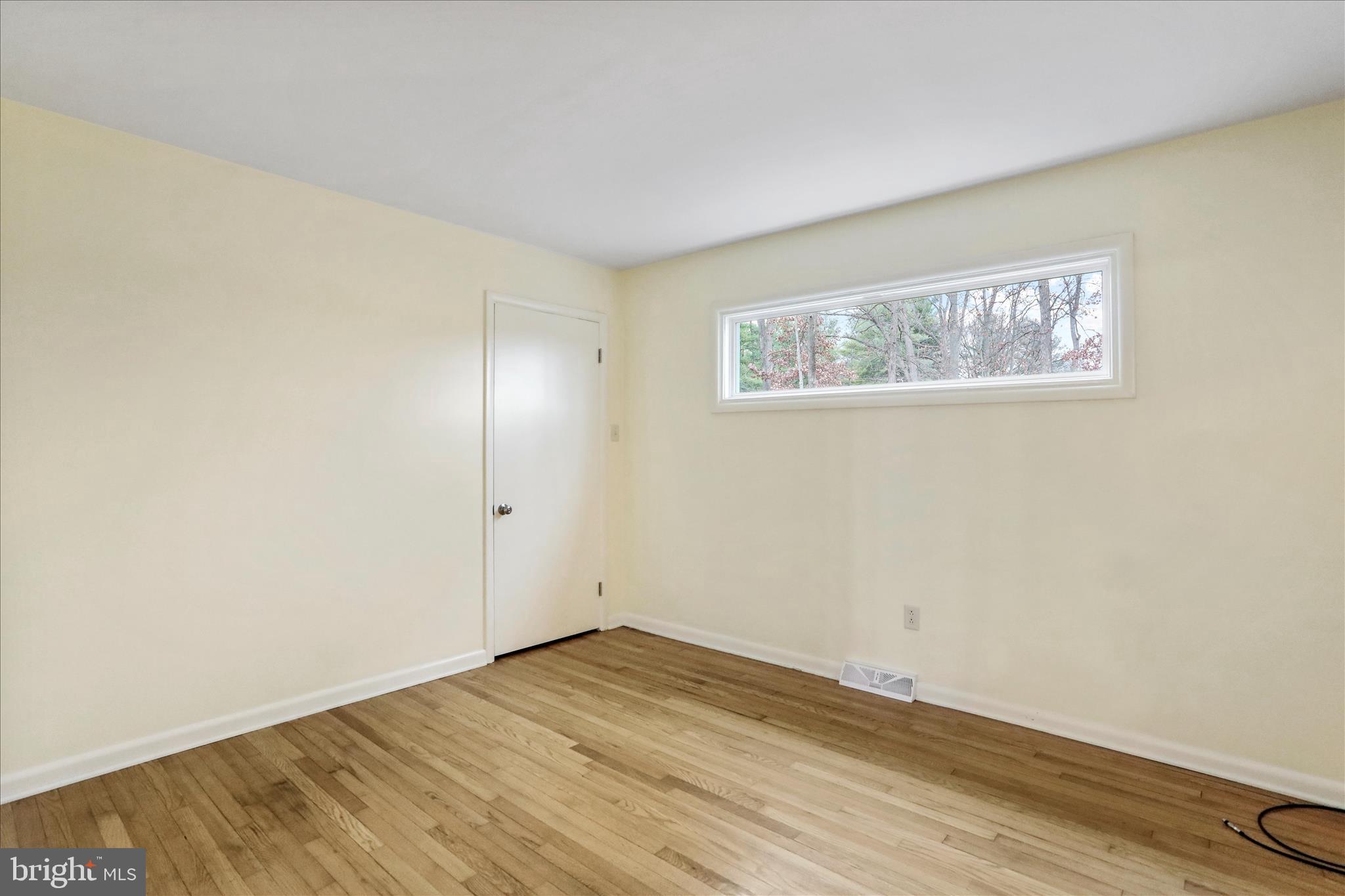 19734 Longmeadow Road Hagerstown, MD 21742 - Photo 20 of 45 an empty room with wooden floor and windows