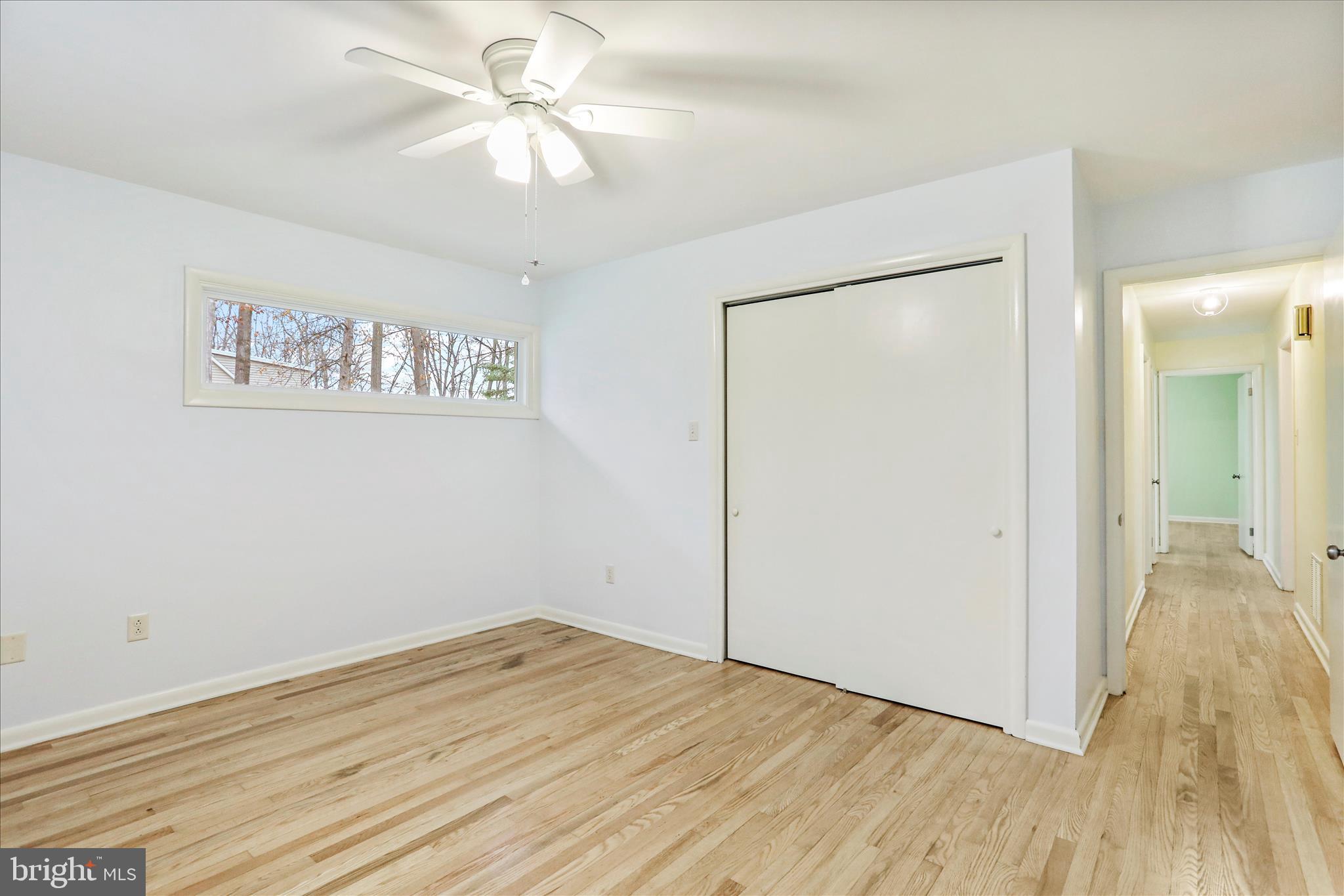 19734 Longmeadow Road Hagerstown, MD 21742 - Photo 23 of 45 wooden floor in an empty room with a fan