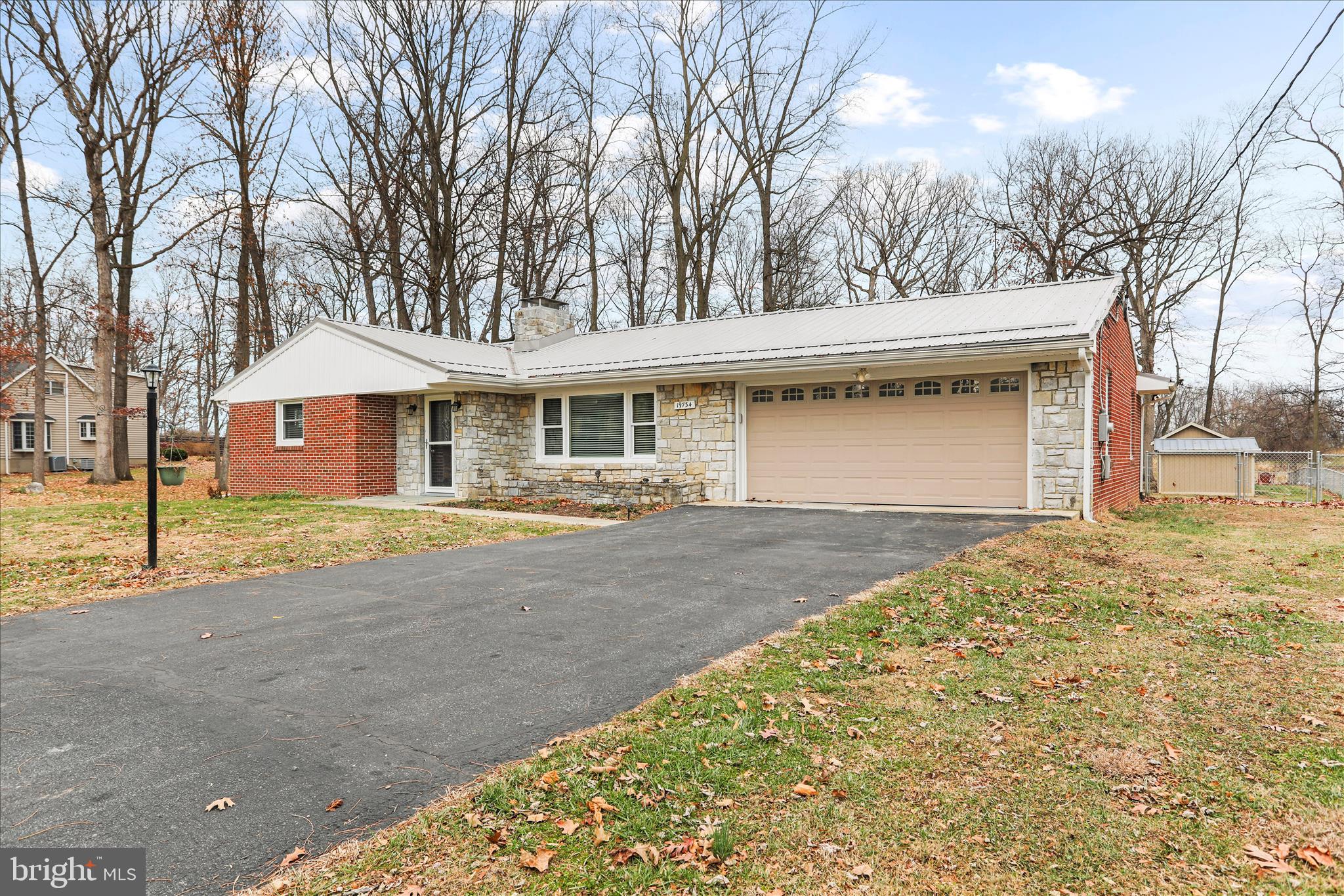 19734 Longmeadow Road Hagerstown, MD 21742 - Photo 4 of 45 a front view of a house with a yard and garage