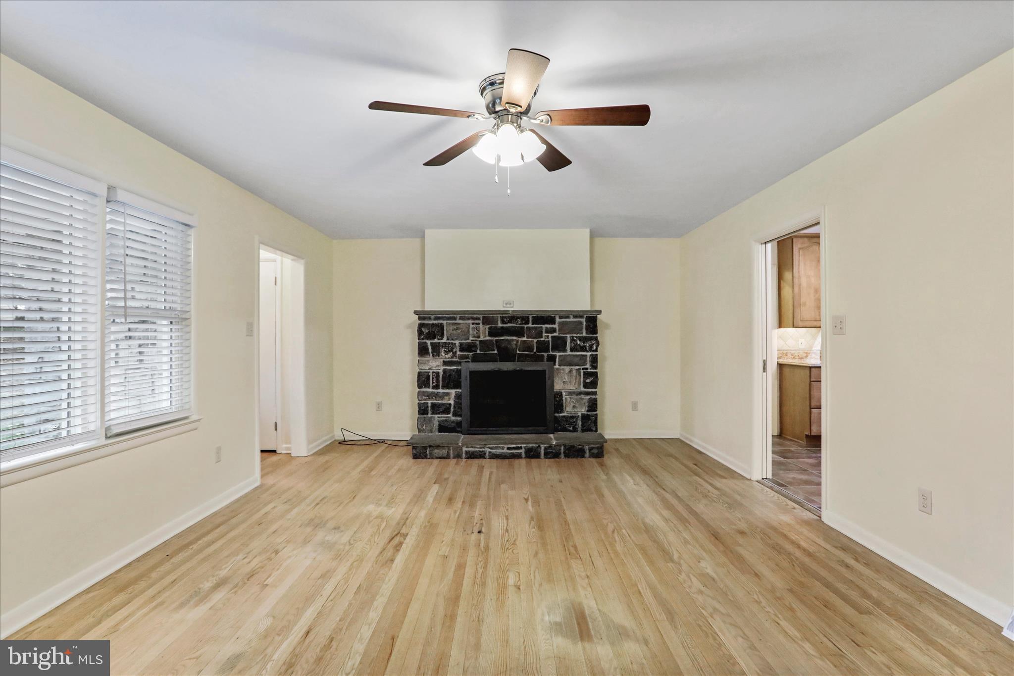 19734 Longmeadow Road Hagerstown, MD 21742 - Photo 6 of 45 a view of an empty room with a window and fireplace