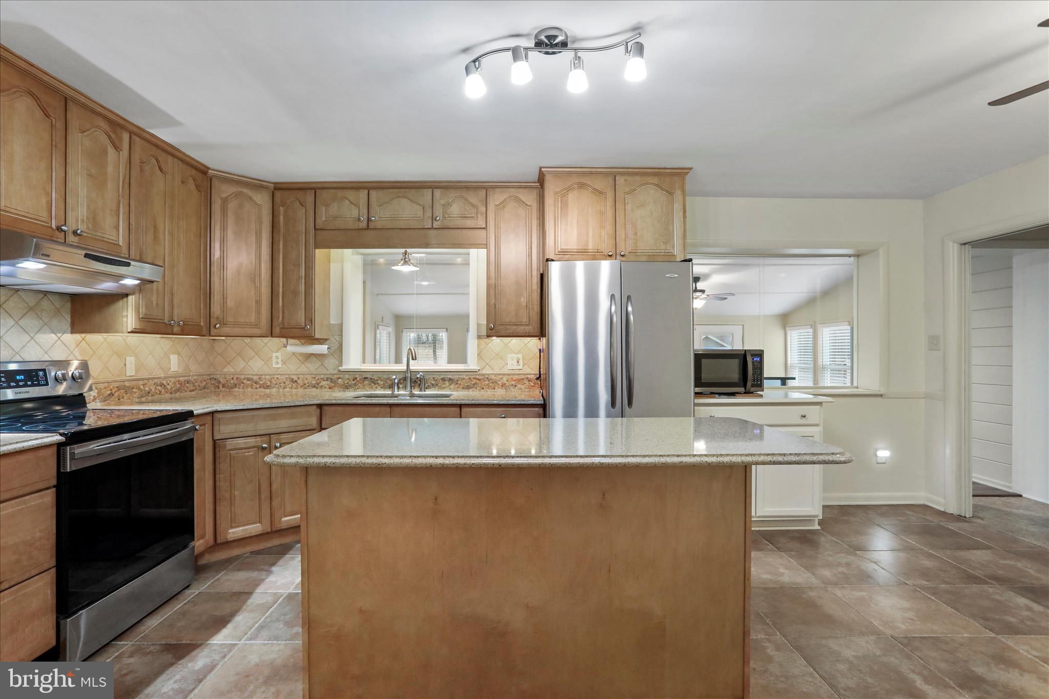 19734 Longmeadow Road Hagerstown, MD 21742 - Photo 8 of 45 a kitchen with stainless steel appliances granite countertop a sink and a refrigerator
