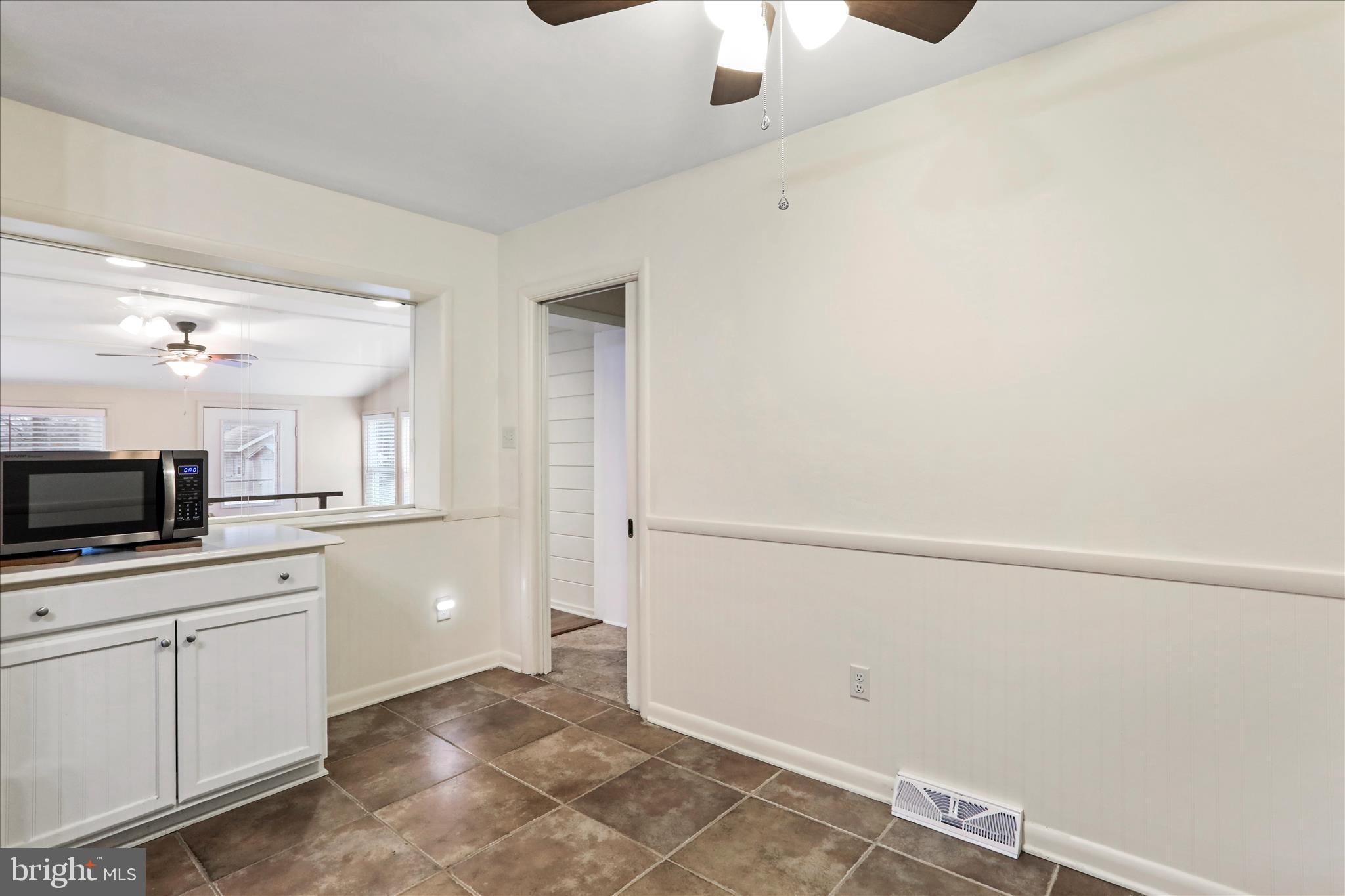 19734 Longmeadow Road Hagerstown, MD 21742 - Photo 10 of 45 a kitchen with white cabinets and white appliances