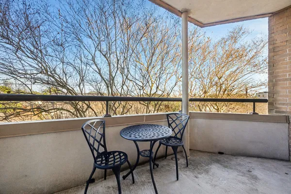 a view of a chairs and table in a balcony