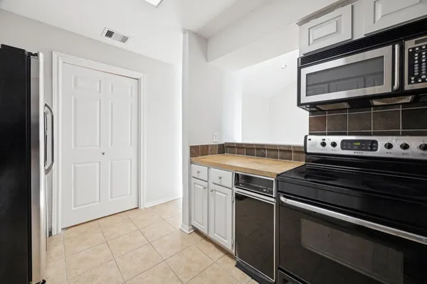 a stove top oven sitting inside of a kitchen