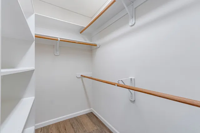 a view of an empty room with a ceiling fan