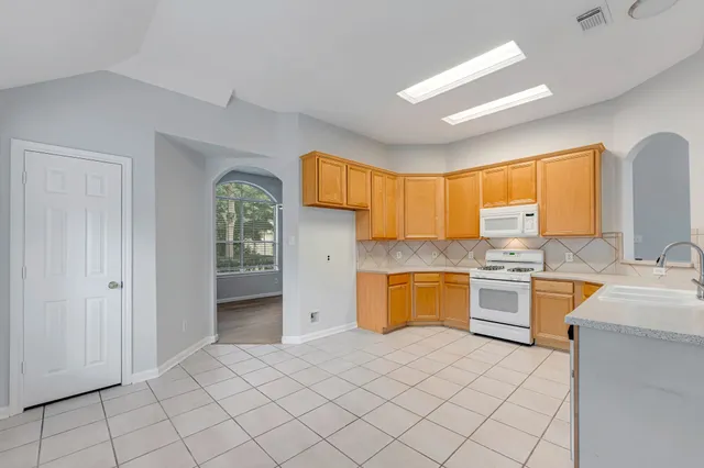 a kitchen with a refrigerator sink and stove
