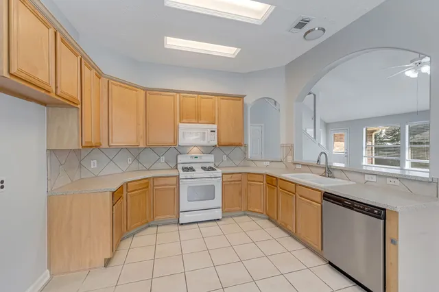 a kitchen with stainless steel appliances granite countertop a sink and cabinets