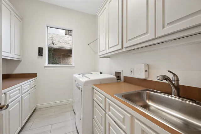 a view of a kitchen sink and cabinets