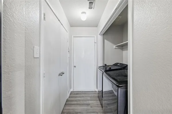 a hallway with a stove and a refrigerator