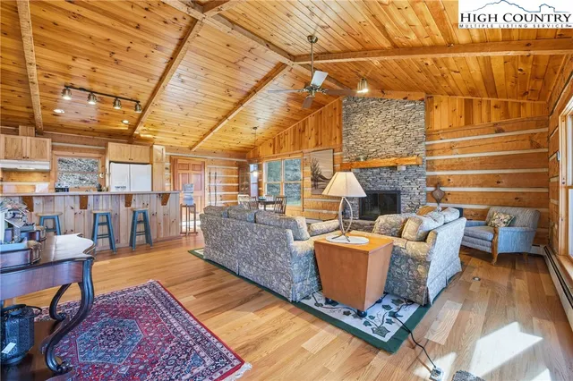 a living room with patio furniture and a rug