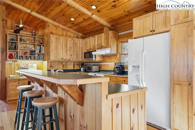 a kitchen with stainless steel appliances a refrigerator and a stove