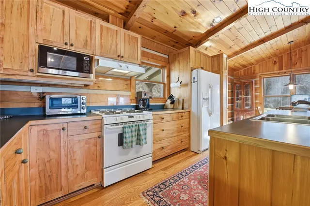 a kitchen with stainless steel appliances granite countertop a refrigerator and a stove