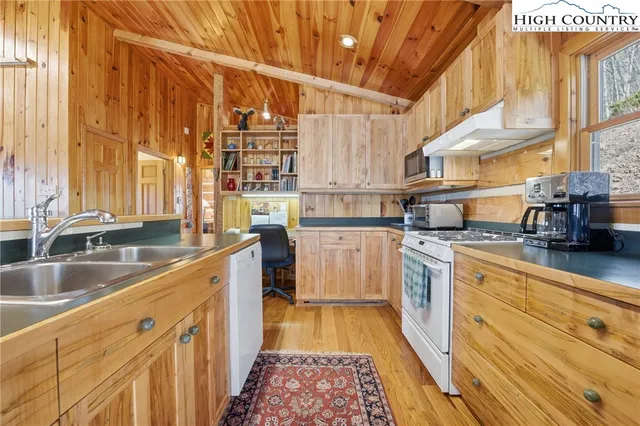 a kitchen with counter top space and wooden floor