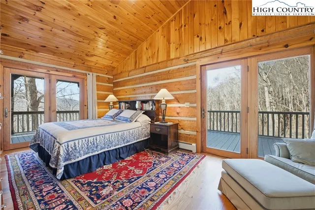 a bedroom with bed and wooden floor