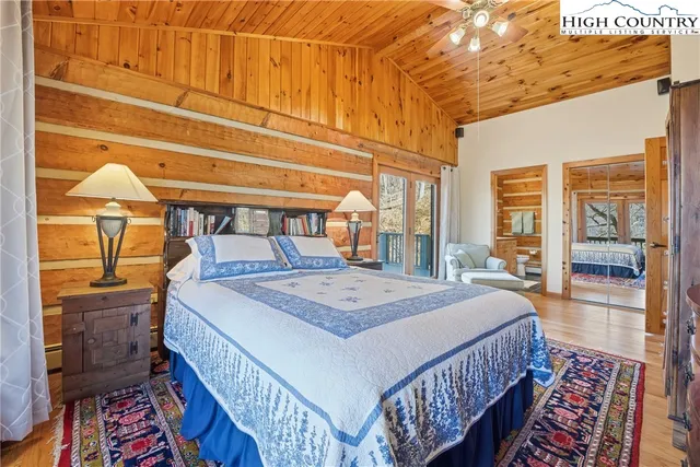 a bedroom with a bed a lamp and window