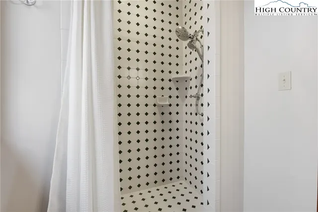 a bathroom with a black white checkered floor
