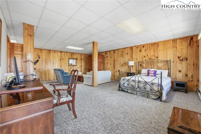 a bedroom with furniture and large window