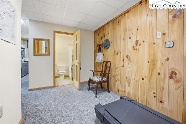 a view of a hallway with bathroom and a shower