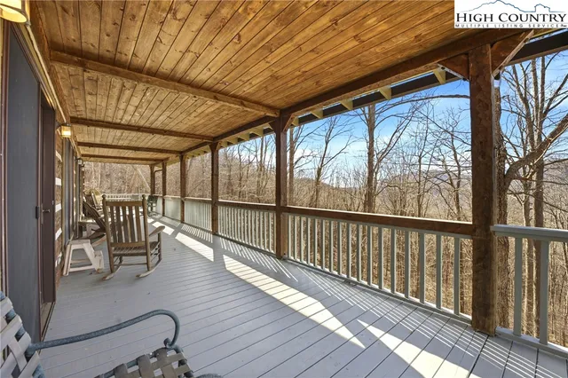 a view of two chairs and wooden floor in balcony