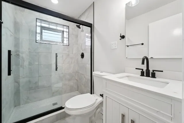 a bathroom with a sink toilet and shower