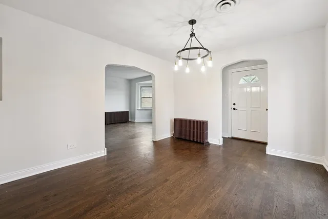 a view of a livingroom with wooden floor and staircase