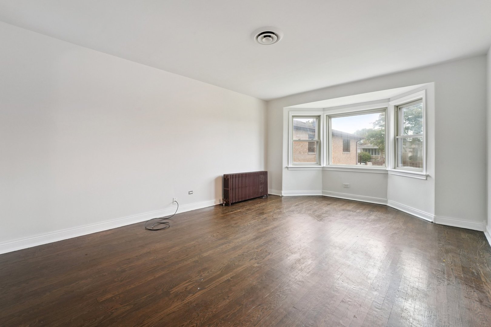 6054 West 64th Street Chicago, IL 60638 - Photo 14 of 29 an empty room with wooden floor and windows