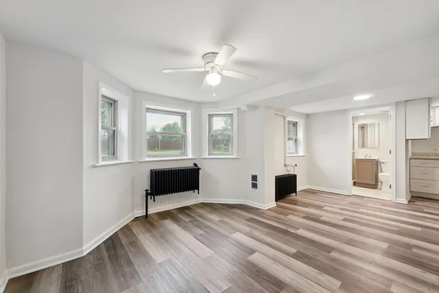a bedroom with furniture window and wooden floor