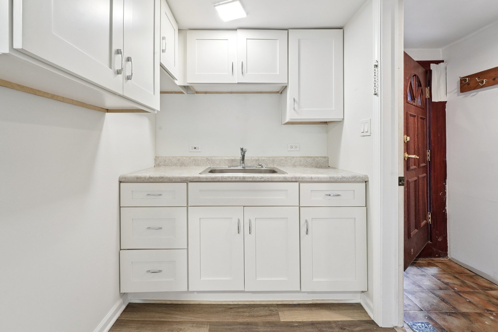 6054 West 64th Street Chicago, IL 60638 - Photo 22 of 29 a kitchen with white cabinets and sink