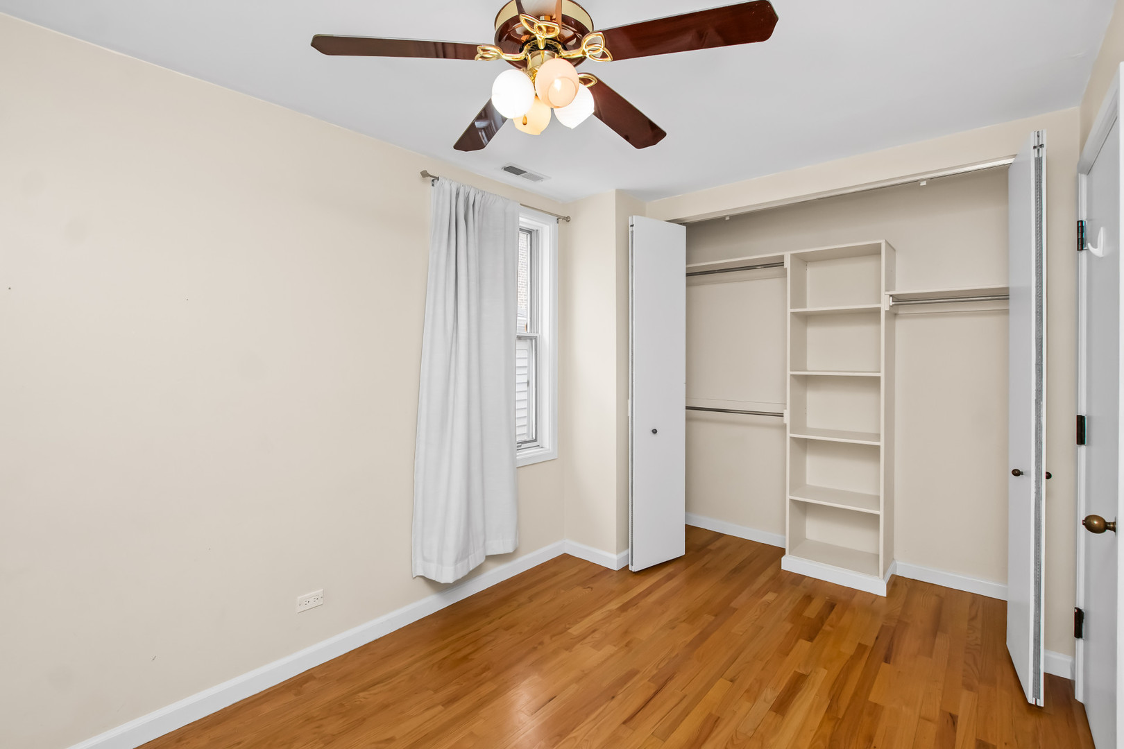 2238 West 21st Place Chicago, IL 60608 - Photo 8 of 37 a bedroom with a bed and a chandelier fan