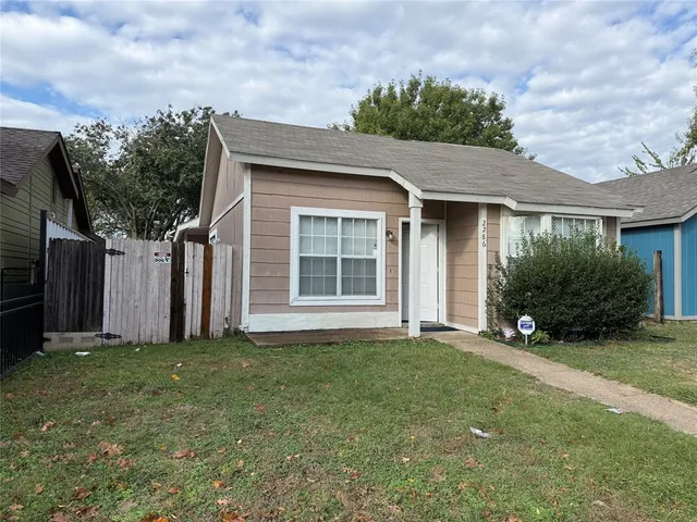 a view of a house with a yard and garage