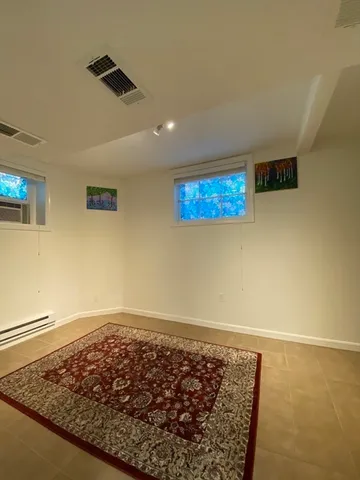 a bathroom with a sink mirror and a toilet