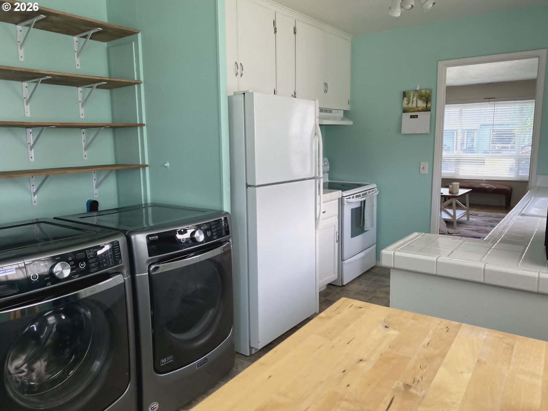 2813 Southwest Ladow Avenue Pendleton, OR 97801 - Photo 5 of 9 a kitchen with a refrigerator and a stove top oven
